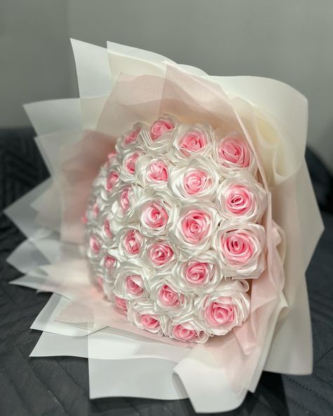 Enjoy the timeless beauty of roses with this exquisite bouquet of satin flowers. Crafted with meticulous attention to detail, each rose has a stunning hue that captivates the eye. These luxurious flowers are expertly arranged into a lush, full bouquet that exudes elegance and sophistication. Whether you're celebrating a special occasion or simply adding a touch of luxury to your home decor, this satin flower bouquet is sure to make a lasting impression. At approximately 10 - 14 inches in diameter, this gorgeous arrangement is the perfect size to grace a tabletop or serve as a breathtaking centerpiece. Experience the charm of these eternal roses and let their timeless beauty enchant you for years to come. - Lasting Elegance: Unlike fresh flowers, these luxurious satin blooms maintain their Artificial Rose Bouquet, Bouquet Eternal Flowers, Satin Bouquet Flower, Eternal Roses Price List, Satin Ribbon Flowers Bouquet, Eternal Roses Bouquet, Eternal Rose Bouquet, Eternal Bouquet Ideas, White Roses Wedding Bouquet