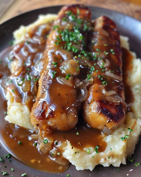 BANGERS AND MASH WITH ONION GRAVY 🌭🥔 Ingredients: For the Bangers and Mash: 8 pork sausages (bangers) 2 lbs potatoes, peeled and cubed 1/2 cup milk 1/4 cup butter Salt and pepper, to taste For the Onion Gravy: 2 tbsp butter 2 large onions, thinly sliced 1 tbsp all-purpose flour 2 cups beef broth 1 tbsp Worcestershire sauce Salt and pepper, to taste Fresh parsley, chopped (optional, for garnish) Directions: Step 1: Cook the Sausages In a large skillet over medium heat, cook the sausages f... Sausage And Mash, Threat Intelligence, Pork Sausages, Gravy Ingredients, My Happy Marriage, Bangers And Mash, Food Fest, Onion Gravy, Food Mood