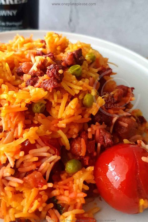 The Chorizo Pulao is nothing but a simple Pulao infused and elevated with the flavour punch of the Goan Chorizo- smoky, spicy, tangy and mild sweet bounty of flavours in every spoonful. Whether it be a lazy weekend or a weekday dinner, it can be prepared in no time, without much fuss, providing the family with a hearty, filling meal. Chorizo Rice, Weekday Dinner, Lazy Weekend, Clarified Butter, Green Peas, Basmati Rice, Filling Recipes, Diced Tomato, One Pot