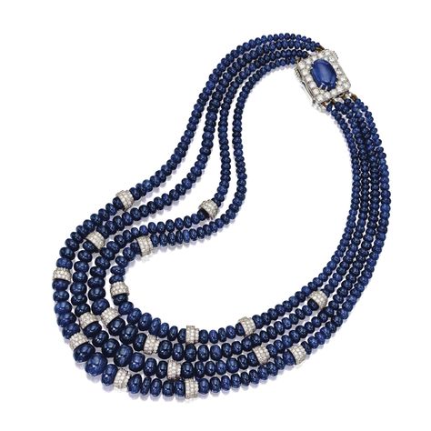 SAPPHIRE AND DIAMOND BEAD NECKLACE, DAVID WEBB The four-strand necklace composed of numerous sapphire beads graduating from approximately 10.5 to 3.1 mm., enhanced with 18 rondelles set with numerous small round diamonds weighing approximately 11.50 carats, completed by a rectangular clasp centering an oval cabochon sapphire weighing approximately 8.30 carats, framed by additional round diamonds weighing approximately 2.00 carats, mounted in platinum and 18 karat white gold, signed Webb. Blue Sapphire Jewelry Set, Diamond And Sapphire Necklace, Blue Beads Necklace, Sapphire Beads, David Webb, Necklace Clasps, Sapphire Jewelry, Elegant Necklaces, Bead Jewellery