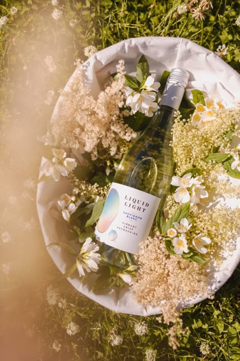 Summer wine vibes, wildflowers bring out vibrance in Sauvignon Blanc Wine Brand Photography, Summer Wine Photography, Wine Campaign Ideas, Wine Styling, Wine Product Photography, Wine Vibes, Flowers And Wine, Wine And Flowers, Wine Bottle Photography