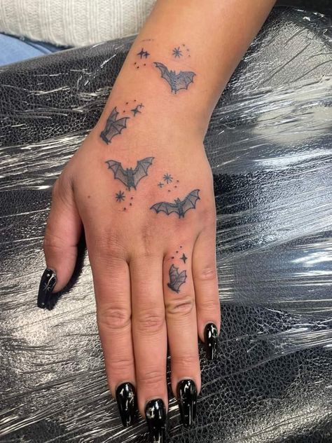 Halloween Tattoo Hand, Little Bats Tattoo, Halloween Hand Tattoos For Women, Collar Bone Tattoo Bats, Bat Hand Tattoos For Women, Bat Finger Tattoo, Bat And Stars Tattoo, Bat Hand Tattoo, Bats And Stars Tattoo