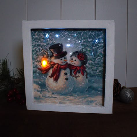 LED / Fiber Optic Lit Canvas Rustic Barn Wood Frame Sits on shelf or hangs with sawtooth hanger Timer - 6 hours on / 18 hours off 8" x 8" x 2" Battery Operated AA (not included) Art by Dona Gelsinger About the Art: Looking for the perfect way to express your love this holiday season? Look no further than our Snow Much in Love Lighted Shadow Box. Featuring two adorable snowmen, snuggled up close and gazing lovingly into each other's eyes, this charming piece is sure to warm your heart. With their Shadow Box Art Christmas, Christmas Box Frames Ideas, Small Shadow Box Ideas, Christmas Shadow Box Ideas, Shadow Box Crafts, Lighted Glass Blocks Diy, Christmas Box Frames, Diy Christmas Shadow Box, Drawer Art