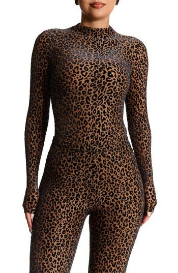 A burnout pattern textures a beautiful velvet bodysuit made for a night out on the town. Snap closure Funnel neck Long sleeves Lined 68% polyester, 25% nylon, 7% spandex Hand wash, dry flat Imported