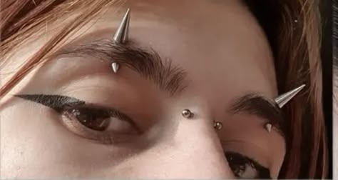 Weird Piercings Places, Goth Face Piercings, Spiked Eyebrow Piercing, Symmetrical Face Piercings, Eyebrow Piercing Spike, Horn Implants, Mouth Piercings Lips, Types Of Piercings Face, Eyebrow Jewelry Piercings