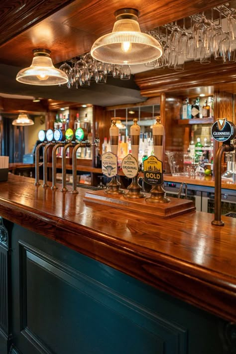 Glossy wooden bar with glasses hung above and with a variety of beers on draught. Bar And Pub Design, Australian Pub Interior, English Pub Home Bar, Pub Interior Ideas Modern, Pub Lighting Ideas, Pub Astethic, Traditional Pub Interior, Irish Bar Design, Pub Bar Ideas