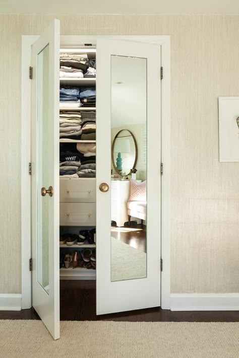 Bi-fold mirrored closet doors with brass knobs in a transitional walk-in girls bedroom closet featuring tan raffia wallpaper. Mirrored Closet Doors, Mirrored Closet, Transitional Bedroom Design, Mirror Closet, Closet Mirror, Bedroom Closet Doors, Mirror Closet Doors, Bifold Closet Doors, Chic Dining Room