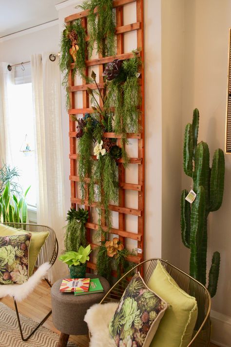 It's all about vertical gardening with a wooden trellis layered with greenery.  Wall color by Hirshfield's - Polished 0209 Indoor Trellis Wall Decor, Indoor Wall Trellis Ideas, Lattice Wall Indoor, Room Divider Plants Green Walls, Lattice Plant Wall Trellis Ideas, Greenery In Hyacinth Basket On Wall, Mediterranean Wall Decor, Indoor Trellis, Lattice Wall