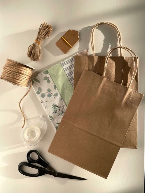 gift wrapping | brown gift bag | tissue paper | brown gift tags | twine | scissors | tape | gift giving | presents | gifts Gift Bag With Tissue Paper, Wood Countertops, Present Gift, Tissue Paper, Paper Shopping Bag, Twine, Gift Bag, Gift Tags, Gift Wrapping