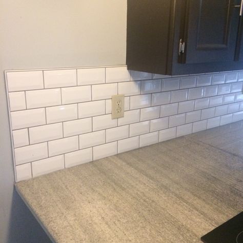 Bright white bevel subway tile with dark grey grout. Very happy with the result. Completely changes the look of my kitchen. White Tile Grey Grout Kitchen, Utility Tiles, White Kitchen Tiles Grey Grout, Grey Tile Grout, White Tiles Grey Grout, Black Home Design, Beveled Subway Tile Backsplash, White Beveled Subway Tile, Bevelled Tiles