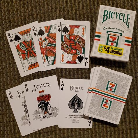 This was bought as a new unwrapped deck from a fellow card collector in a Facebook group. (Of course I opened them) This is the 2018 Bicycle brand made for & distributed thru 7-11 convenience stores. Inside there are 2 extra cards to redeem for store products. The court cards have green and orange like the 7-11 logo. On the box it has their advertising line "Oh thank heaven!" and the 7-Eleven logo but the cards only have the logo. 7 11 Logo, Court Cards, Bicycle Brands, 7 Eleven, Game Ideas, 7 11, The Court, Facebook Group, Green And Orange