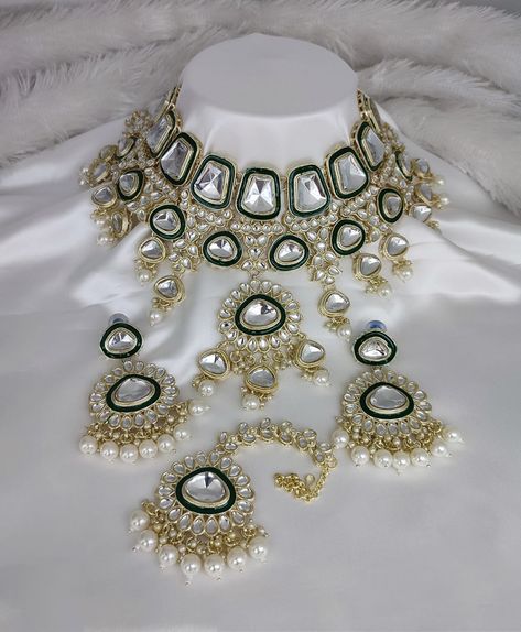 Embrace timeless elegance with this stunning white crystal glass Kundan necklace set, featuring an artful blend of traditional craftsmanship and contemporary design. This luxurious set includes:
Design Elements:
• Large crystal glass stones in unique geometric settings
• Multi-layered Kundan work with green white  detailing
• Cascading pearl drop embellishments
• Matching statement earrings
• Coordinating maang tikka
• Antique gold finish framework
Perfect For:
• Wedding ceremonies
• Engagement celebrations
• Cocktail receptions
• High-end formal events
Craftsmanship Details:
• Premium quality crystal glass stones
• Hand-set Kundan work
• Double-layered pearl drops
• Delicate green white work
• Secure closure system
• Lightweight comfortable design
This ethereal set combines the brilliance Kundan Choker Set, Kundan Work, Kundan Necklace Set, Kundan Choker, Maang Tikka, Kundan Necklace, Large Crystal, Choker Set, Comfortable Design