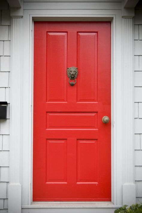 Off-white molding and framing support this bright red door, which has five rectangular panels and features a bronze doorknocker and a bronze doorknob. A black mailbox fixed to the wall is placed at the left side of the door. Red Door House, Vinyl Door, Red Doors, Red Front Door, House Porch, Exterior Stairs, Door Paint Colors, Door Colors, Painted Front Doors