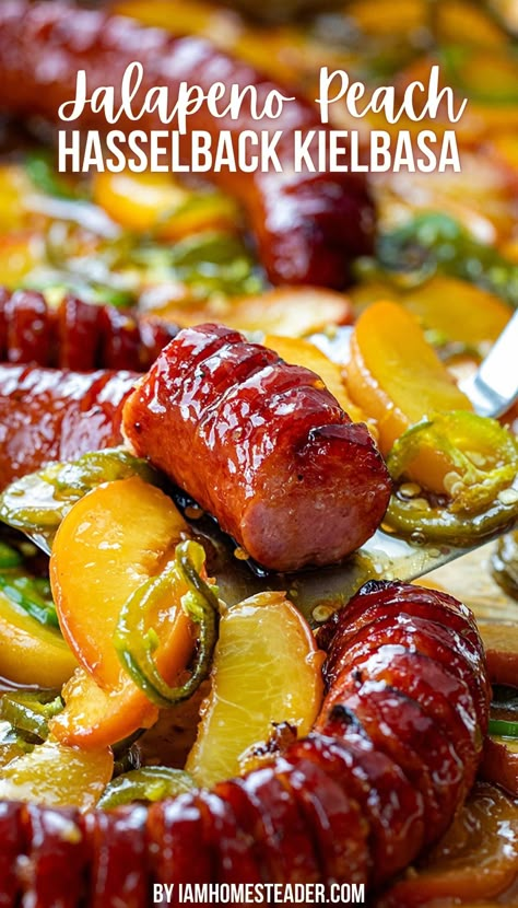 The image is a close up of hasselback kielbasa with peach slices and jalapeños. Kielbasa Charcuterie Board, Cajun Kielbasa Recipes, Kielbasa Sweet Potato Recipes, Sweet And Spicy Kielbasa Crock Pot, Smoked Kielbasa Recipes, Jalapeno Sausage Recipes, Hasselback Kielbasa Bites, Keilbasa Sweet Potato Recipes, Kalbasa Dinner Recipes