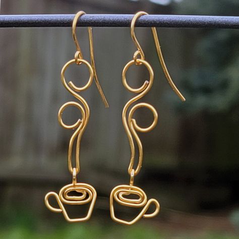 These beautiful, handcrafted coffee earrings are wire wrapped out of high quality non-tarnish coated copper wire and are perfect for coffee lovers! WIRE COLORS: Gold, Silver, Rose Gold, Vintage Bronze and Antique Copper. EAR WIRES: While the main earring design is made from a copper core wire (explained below), the ear wires are made out of 100% hypoallergenic Niobium -- making them safe to wear for those with sensitive ears. DESIGN WIRE: The wire has a copper core, with a high quality non-tarnish coating. So, you have the benefits of wearing copper, without the greening that affects raw copper. IMPORTANT: All jewelry is handmade to order, so they may not look exactly like the picture. CARE: Store out of direct sunlight and keep away from water. SHIPPING: Rings are shipped inside a cotton Coffee Earrings, Diy Wire Jewelry Rings, Coffee Earring, Wire Jewelry Earrings, Wire Jewelry Rings, Wire Wrapped Jewelry Diy, Wire Jewelry Designs, Earrings Wire, Diy Wire Jewelry