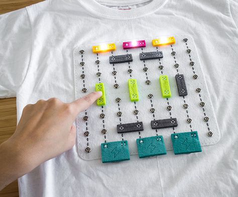 Shirt Circuit is soft wearable breadboard with modular DIY circuit components that can be snapped onto the shirt by the wearer. The motivation behind shirt circuit is to challenge the 'black box' paradigm in which STEM education is often delivered. This is done through making and playing.Making:Shirt circuit comprises of DIY components that children can build collaboratively with the help of their parents, teachers or even other peers. We have broken the making process down into small steps,... Soft Circuits, Snap Circuits, Circuit Components, Paper Circuits, Apple Watch Edition, Wearable Electronics, E Textiles, Stem Projects, Small Steps