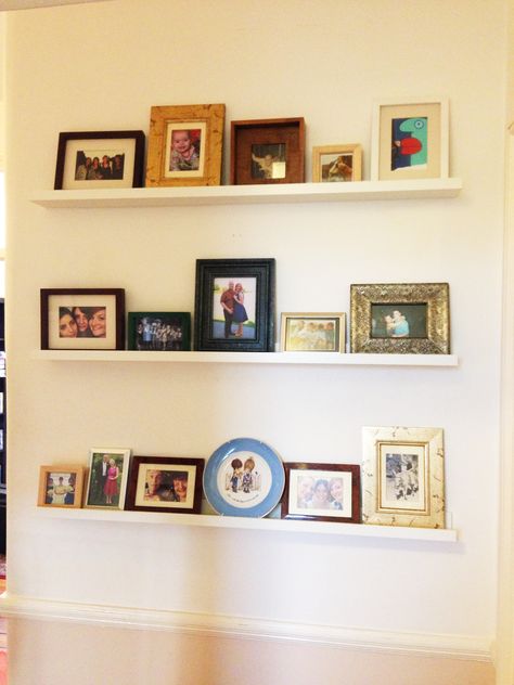 Our photo wall. Mix and match frames and sizes. Mixed Match Picture Frame Wall, Shelves With Colored Picture Frames, Mismatch Frames, Miss Match Picture Frame Wall, Mismatch Picture Frames, Picture Frame Shelves, Wall Shelf Decor, Frame Shelf, Multi Photo