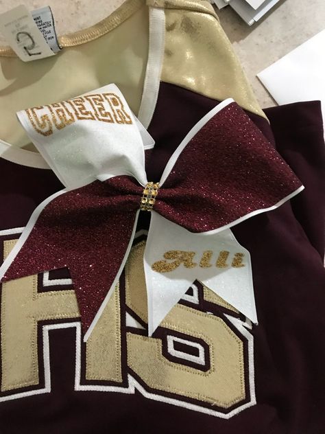 Maroon & white with gold lettering. Cheer & name Maroon And Gold Cheer Uniform, Red And Gold Cheer Uniform, Maroon Cheer Uniforms, Red Cheer Uniforms, Cheer Gym, Varsity Cheerleading, Pe Uniform, Cheer Aesthetic, Cheer Costumes