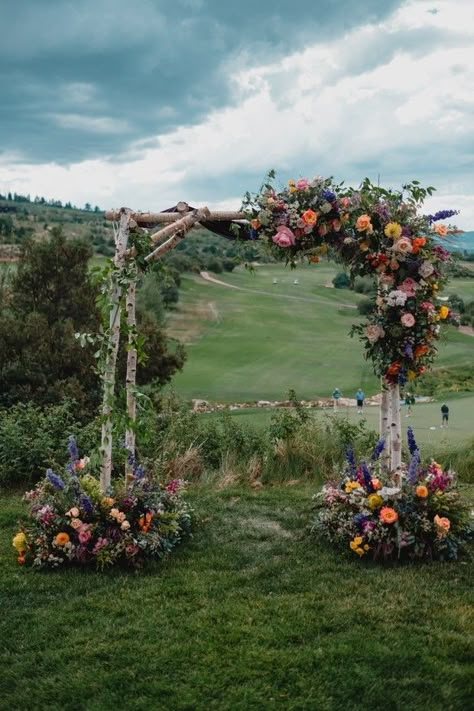 How to Style a Wedding With Colorful Flowers Wooden Flower Arch Wedding, Wedding Arch Flowers Colorful, How To Make Flower Arch Wedding, Colourful Flower Arch Wedding, Wedding In A Field Of Flowers, Decorated Wedding Arches, Wild Flower Arch Wedding, Wedding Flower Arch Outdoor, Wildflower Arch Wedding