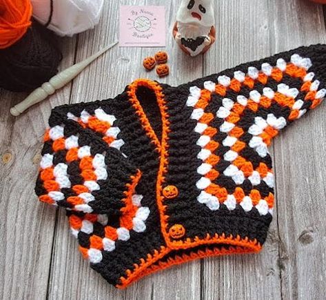 Handmade Crochet Baby Cardigan - Black, White & Orange with Adorable Pumpkin Buttons Wrap your little one in warmth and festive style with this charming crochet baby cardigan. Perfect for autumn or Halloween-themed outfits, this cosy cardigan features a striking colour combination of black, white, and orange that's both playful and sophisticated. The standout detail? Cute pumpkin-shaped buttons that add a delightful seasonal touch. This cardigan is meticulously hand-crocheted with soft, baby-fri Crochet Cow Cardigan, Crochet Halloween Clothing, Halloween Granny Square Cardigan, Halloween Crochet Squares, Christmas Crochet Cardigan, Halloween Crochet Cardigan, Halloween Crochet Clothes, Halloween Crochet Sweater, Fall Crochet Clothes