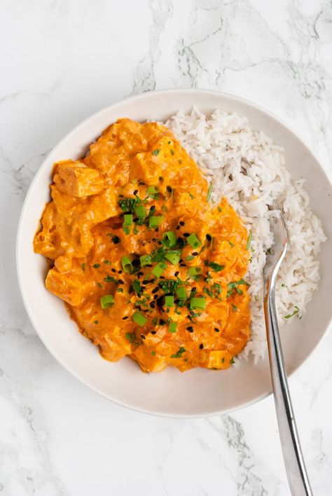 Tofu tikka masala - easy, vegan, and delicious! Tofu is simmered in a spiced creamy tomato and coconut milk sauce in this cozy meatless dish. On the table in under 40 minutes, its a great meatless meal for busy nights. #tofu #vegan #curry #easy #recipe