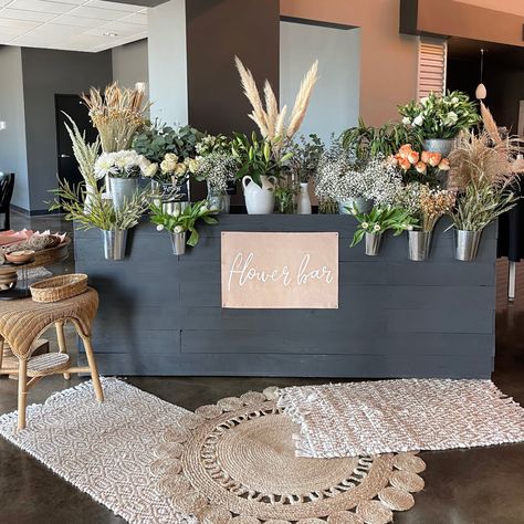 Flower bar, leather sign, Trader Joe’s flowers, women’s event Boho Flower Bar Ideas, Fall Flower Bar Ideas, Stem Bar Flower, Boho Flower Shop, Flower Booth Design, Women's Conference Decor, Flower Vendor Booth, Diy Flower Bouquet Bar, Flower Bar Baby Shower Ideas