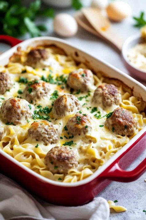 A baked casserole dish of Swedish Meatball Pasta Bake with golden brown meatballs on top of creamy egg noodles, garnished with fresh parsley and served hot. Swedish Meatball Noodle Bake, Creamy Egg Noodles, Swedish Meatball Pasta Bake, Meatballs Noodles, Swedish Meatball Pasta, Meatball Pasta Bake, Savory Meatballs, Meatball Casserole, Meatball Pasta