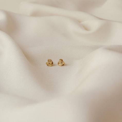 Knots are beautiful and meaningful symbols to represent unity and love. Our Love Knot Studs are timeless, classy, and powerfully symbolic. They'll make the perfect gift or everyday accessory. • Material: High-Quality Solid 925 Sterling Silver• Finish: Sterling Silver ∙ 18K Gold• Featuring 7mm Knot Stud Earrings SKU: RR-ER153 #Embracing #Art #Beauty #Minimalist #Jewelry #Exploring #Simplicity #and #of #The #Elegance #StatementJewelry #the Basic Earrings Studs, Small Gold Tops Designs, Dainty Stud Earrings, Gold Small Earrings Studs, Gold Earrings Studs Daily Wear, Gold Tops Earrings, Ear Studs Design, Small Earrings Gold, Meaningful Symbols