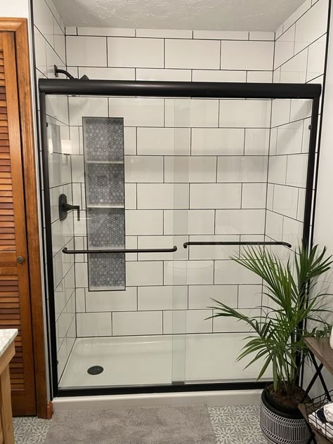 Black Grout White Subway Tile, Big White Subway Tile Bathroom, White Shower Tile Dark Grout, Bathroom Tiles With Black Grout, Subway Tiled Shower Ideas, Large White Tile Black Grout, Large White Tiles Black Grout, White Tile Black Fixtures Bathroom, White Shower Black Grout