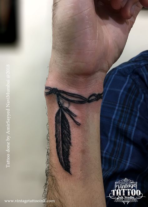 Small Fill In Tattoos For Sleeve Men, Wrist Tattoos Men Band, Mens Wrist Band Tattoos, Feather On Wrist Tattoo, Mens Feather Tattoo Forearm, Rope Around Wrist Tattoo, Men Feather Tattoo Ideas, Tattoo Ideas For Men Arrow, Mens Native Tattoos