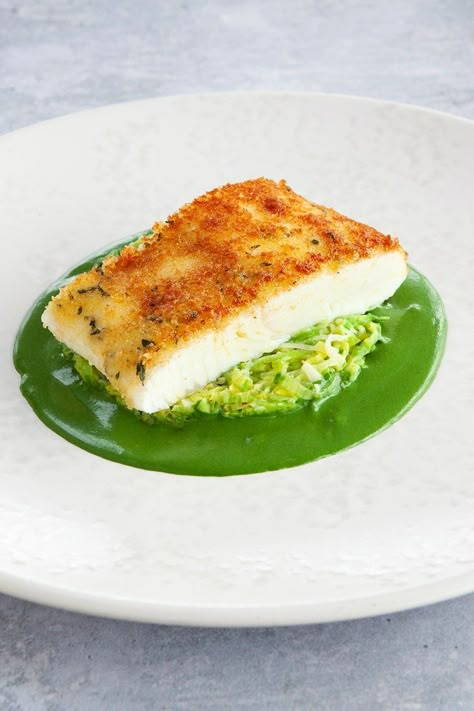 Halibut is an incredible fish to cook with, as its pearlescent white flesh retains its meaty, clean flavour and texture if handled delicately. Here, the fillet is placed centre stage, bolstered by a buttery parsley sauce, simply cooked leeks and a crisp, rich Gruyère cheese crust. Serve with buttered potatoes on the side. Leek Fondue, Plated Meals, Crusted Halibut, Halibut Recipe, Parsley Sauce, Fish Breading, Parsley Recipes, Leek Recipes, Halibut Recipes