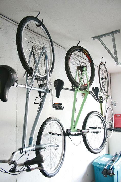 Three bikes hanging from hooks in a garage Bike Storage Wall, Hanging Bike Rack, Bike Storage Home, Garage Bike Storage, Bicycle Wall Mount, Bike Storage Garage, Bike Storage Solutions, Door Makeover Diy, Garage Floor Paint