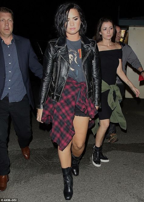 Trendy: Demi Lovato looked nineties chic in black shorts, a graphic T-shirt, leather jacket and red plaid top tied around her waist Tied Around Waist Outfits, Demi Lovato Style Outfits, Shirt Tied Around Waist, Demi Lavato, Demi Lovato Style, Sugar Mommy, Cowgirl Style Outfits, Dark Style, Style Goals