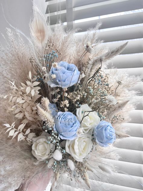 The dreamiest wedding flowers that you can keep forever!  Pastel blues, creams, whites and neutral tones throughout!  Bouquets delicately hand tied with champagne silk draped ribbon, giving the perfect boho touch..  The bouquets are filled with beautiful dried and preserved florals, so no water or maintenance is needed for your florals and you can keep them looking as fresh as ever for over 10 years.. Choose from buttonholes, bridesmaids or bridal bouquets for your order, Or better yet all three Blue And Cream Wedding Bouquet, Boho Dried Flower Bouquet, Blue And White Bridesmaid Bouquet, Pale Blue Wedding Theme, Lavender Beach Wedding, Blue Bridesmaid Bouquet, Wedding Bouquets Blue, Cornflower Blue Wedding, Country Wedding Bouquets