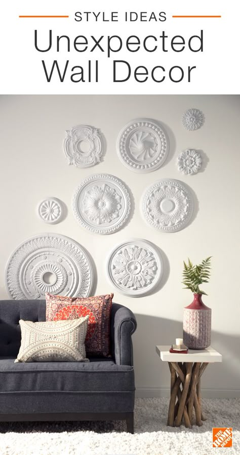 Create unexpected and interesting wall decor with ceiling medallions. A white-on-white gallery wall is minimal yet modern when paired with Swedish-farmhouse furniture and subtle pops of color. Try using this decor hack in your home to create an eye-catching monochromatic look. Click to explore the space. Pop Wall Decor, Wall Medallion Decor, Interesting Wall Decor, Ceiling Medallion Wall Art, Decor Above Couch, Above Couch, White Wall Decor, Diy Ikea Hacks, Farmhouse Furniture