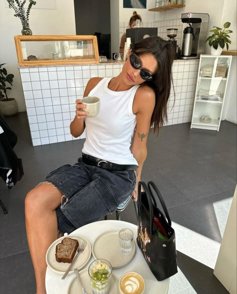 Coffee Shop. White Tank Top. Grey Cut Off Shorts. Black Sunglasses. Summer Coffee Shop Outfit, Cafe Inspo Pics, Cafe Aesthetic Pose, Coffee Shop Aesthetic Outfits, Cafe Photoshoot Ideas, Cafe Pose Ideas, Coffee Dates Aesthetic, Coffee Shop Photoshoot, Cafe Pose