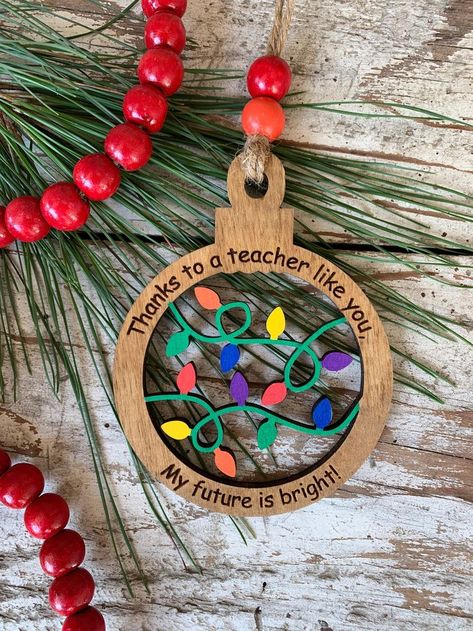 Celebrate your favorite teachers with unique Christmas ornaments. Explore ideas for personalized gifts, including engraved ornaments and DIY projects that show your appreciation. Best Teacher Ornament, Wooden Teacher Ornaments, Glowforge Ornament Ideas, Wecreat Laser Projects, Thank You Ornament, Xtool M1 Project Ideas Christmas, Diy Teacher Ornaments, Christmas Laser Projects, Wood Cut Ornaments