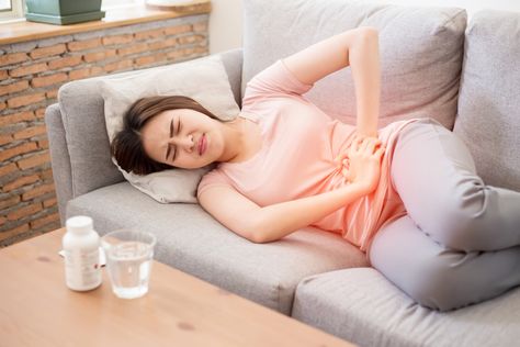 Woman clutching her abdomen in menstrual pain Thigh Cramps, Severe Menstrual Cramps, Bedtime Stretches, Lower Abdominal Pain, Period Pain Relief, Period Cramps, Menstrual Period, The Cramps, Menstrual Pain