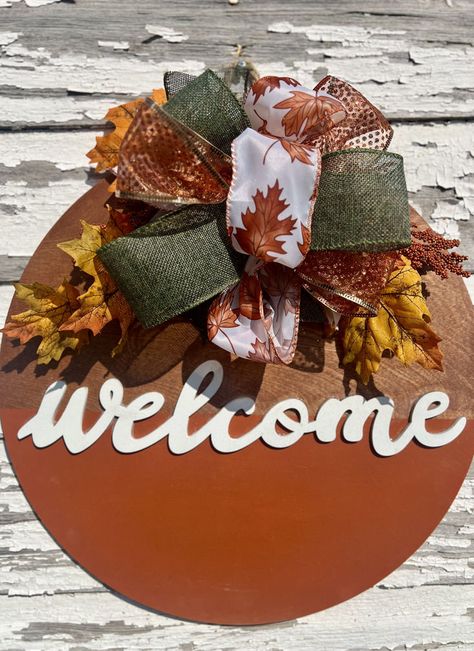 🍂✨ Welcome the cozy vibes of fall with our charming round door sign! Perfect for adding a touch of autumn warmth to your home, this beautifully crafted piece features stunning seasonal colors and inviting designs. 🧡🍁 Transform your entryway into a festive haven and greet your guests with style! 🌟 👉 Tap to shop now and make your front door the talk of the neighborhood! 🏡🍂 #FallDecor #WelcomeHome #AutumnVibes Round Wooden Door Hangers Diy, Fall Wooden Door Hangers, Fall Door Sign, Fall Front Door Decor, Fall Door Hanger, Rustic Door, Door Hangers Diy, Wooden Door Hanger, Fall Door Hangers