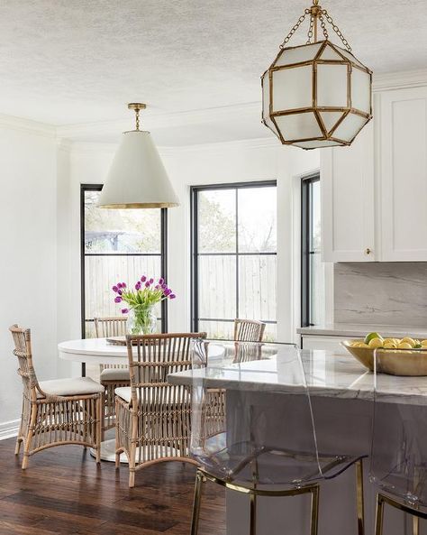 Suzanne Kasler Morris Lanterns are positioned above a gray kitchen island seating acrylic and brass stools at a marble countertop. Brass Stools, Morris Lantern, White Kitchen Island Lighting, Kitchen Island Finishes, Acrylic Counter Stools, Island Seating, Marble Tile Backsplash, Gray Island, Blue Kitchen Island