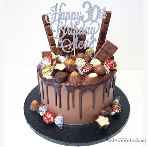 Chocolate cake loaded with a selection of Lindt chocolate Chocolate Cake Decorated With Chocolates, Loaded Chocolate Cake Decoration, Lindt Cake Birthday, Loaded Birthday Cake, Chocolate Loaded Cake Decoration, Loaded Chocolate Cake, Chocolate Loaded Cake, Lindt Chocolate Cake, Lindt Cake