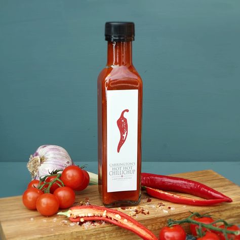 Hot Hot Chillichup, a hot chilli and tomato sauce combined with Middle Eastern spices and scotch bonnet chillies. A medium heat hot sauce that can be used as a ketchup or in cooking. This sauce is perfect for any serious chilli connoisseur, foodie or aspiring chef it is sweet to taste with a bold chilli kick and goes perfectly with meat, fish and vegetables. To be used as an accompaniment, a marinade or in cooking to add Spice and flavour to your food. A great gift for him or her. Deliciously ve Hot Sauce Photoshoot, Sauce Bottle Photography, Ketchup Product Photography, Chili Sauce Packaging Design, Chili Sauce Label Design, Chilli Sauce Product Photography, Hot Sauce Product Photography, Chilli Sauce Packaging, Spicy Ketchup