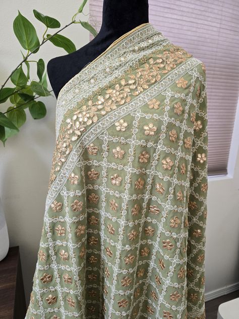 Add a touch of elegance to your wardrobe with this beautiful piece of splendid Georgette Dupatta. Swathed with Lucknowi work all over along with gorgeous gold gotta patti work, this versatile stunner is a must in your collection. This splendid Lucknowi embroidery dupatta with gold gotta patti work will definitely be a special addition to your closet. Size: 2.4 metres, Fabric: Georgette A perfect wear for parties, weddings and festivities. Team up this dupatta with both kurtas, lehengas, anarkali, skirts for timeless signature styles. Lucknowi Embroidery, Gotta Patti Work, Embroidery Dupatta, Gotta Patti, Signature Styles, Georgette Dupatta, Closet Size, Anarkali, Signature Style