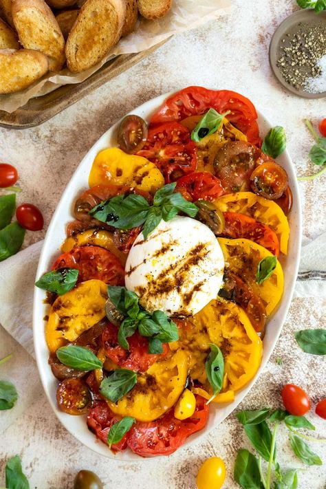 This burrata caprese appetizer recipe is filled with large heirloom tomatoes and creamy cheese. The perfect summer salad, topped with a drizzle of balsamic glaze and a generous drizzle of olive oil. Heirloom Tomato Burrata Salad, Heirloom Tomatoes Recipes, Burrata Caprese Salad, Salad With Burrata, Burrata Caprese, Caprese Recipe, Caprese Appetizer, Gluten Free Recipes Appetizers, Caprese Recipes