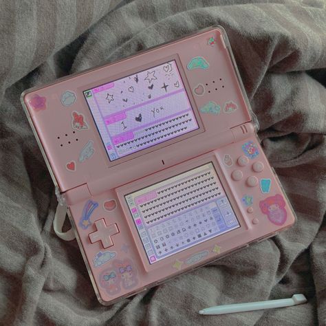 i bought a pink nds lite and put stickers on it :D im planning to get the sega card reader to play love and berry on it. Ds Lite Pink, Pink Ds Lite, Pink Ds Aesthetic, Nintendo Ds Decoration, Nintendo Ds Lite Aesthetic, Ds Lite Aesthetic, Playing Games Aesthetic, Nintendo Ds Aesthetic, Pink Nintendo Ds