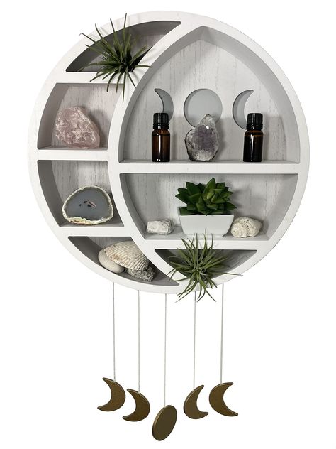 PRICES MAY VARY. This moon phases wall art can be used in the bedroom, living room, bathroom or ANY room; has 7 display shelves for showing all your art, collectibles, oils, stones and much more! Possibilities are endless with this floating shelf; fits with Nursey, Wiccan, Hippie, Boho, Spiritual, Rustic, Goth Decors; gives a magical feel to any space. Our full moon with crescent design is crafted from high quality pine wood to be extra thick and sturdy. This crystal holder provides a stable and Moon Wall Shelf, How To Display Crystals And Stones, Spiritual Room Ideas, Celestial Bedroom, Spiritual Room Decor, Shelf For Wall, Boho Spiritual, Moon Phase Wall Hanging, Moon Shelf