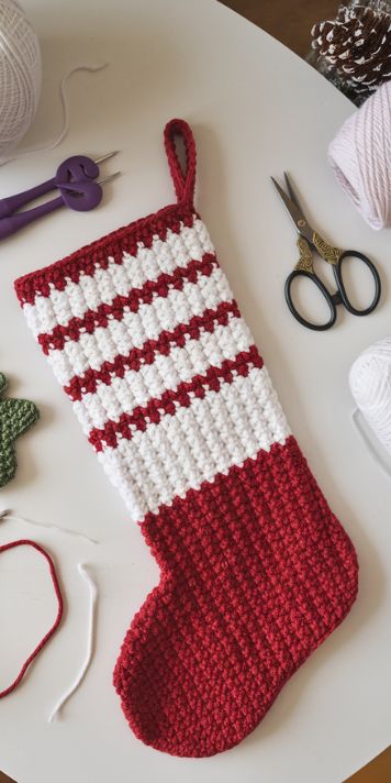 Crocheted Christmas stocking made with a free pattern – perfect for festive holiday decor – click to get the pattern. Crochet Stocking Garland Pattern Free, Free Crocheted Christmas Stocking Pattern, Crochet Grinch Stocking Pattern Free, Easy Crochet Christmas Stocking Pattern, Free Crochet Christmas Stockings Patterns, Stockings Crochet Pattern Free, Crocheted Mini Christmas Stockings Free, Granny Square Stocking Crochet, Crochet Small Christmas Stocking