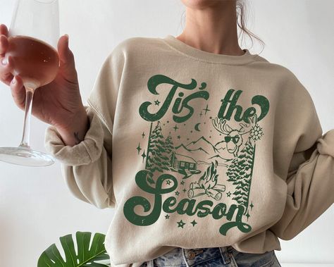 Womens Winter Sweatshirt, Christmas Sweater, Cozy Sweatshirt, Christmas Crewnck, Tis the Season Winter Sweatshirt, Winter Sweater, Xmas Top This crewneck sweatshirt is pure comfort. Made from a soft cotton/poly blend with no itchy side seams, this is sure to become a staple. SIZE AND FIT: Your sweatshirt design will be printed on a high-quality, soft and comfortable unisex sweatshirt. Sizes run true to size, which takes the guesswork out of ordering; if you like your sweatshirts loose or oversized, you might want to order a size up and if you'd like a more fitted women's style then order a size down. Sizes range from S - 3X. Please refer to our size chart in the photos for exact dimensions. DETAILS AND FABRIC: * 50% Cotton 50% Polyester * Medium-heavy fabric (8.0 oz/yd² (271.25 g/m * Loose Winter T Shirt, Christmas Merch, Trendy Winter Graphic Sweatshirt, Winter Designs, Christmas Crewneck, Winter Crew Sweatshirt With Screen Print, Winter Graphic Print Comfortable Sweatshirt, Winter Crew Sweatshirt With Text Print, Winter Vintage Graphic Print Sweatshirt