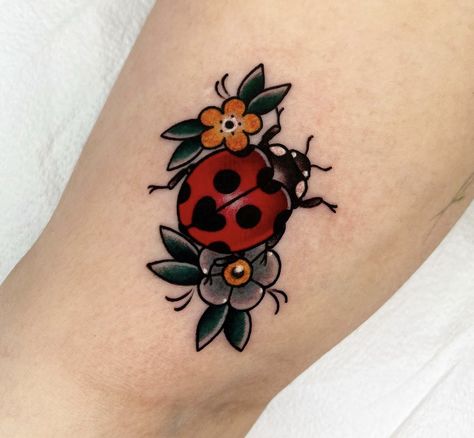 Traditional Style Ladybug Tattoo, Pretty Tattoos Traditional, Cute June Bug Tattoo, Old School Ladybug Tattoo, Cute Bug Tattoos For Women, Ladybug With Flower Tattoo, Traditional Ladybug Tattoo Black, Ladybug Tattoo American Traditional, Traditional Colored Tattoos