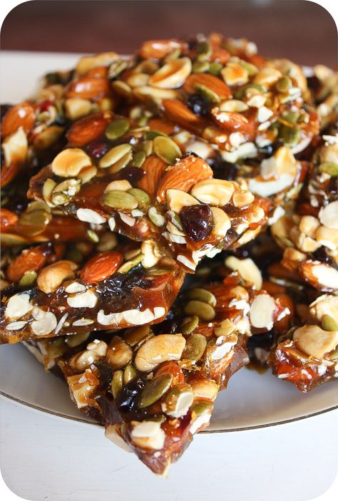 Several weeks ago I tried a new snack from Costco called “Cashew Clusters” and became completely obsessed with it. It is amazingly and utterly delicious! They’re these kind of granola chunks with cashews, pumpkin seeds and almonds in them. I decided to try to make a brittle using mostly the same ingredients, but added some... Brittle Recipes, Sukkot, Dessert Bar, Dried Cranberries, Pumpkin Seeds, Granulated Sugar, Golden Brown, Junk Food, Appetizer Snacks